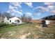 Expansive fenced backyard with a charming shed and inviting outdoor seating around a fire pit at 7034 Pin Oaks Dr, Denver, NC 28037