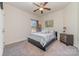 Cozy bedroom with neutral decor, comfortable bed, ceiling fan, carpeted floor and a nice view outside the window at 7034 Pin Oaks Dr, Denver, NC 28037