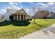 Well-maintained home featuring a lovely front lawn and a mix of stone and vinyl siding under a cloudy sky at 7034 Pin Oaks Dr, Denver, NC 28037