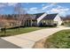 Inviting single-story home with a long driveway and well-kept front lawn at 7034 Pin Oaks Dr, Denver, NC 28037