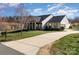 Attractive single-story home with a large driveway, well-kept lawn and appealing stone and siding at 7034 Pin Oaks Dr, Denver, NC 28037