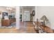 Inviting home foyer with wood floors, featuring a home office to the left and a clear view to the front door at 7034 Pin Oaks Dr, Denver, NC 28037