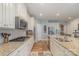 Bright kitchen with granite countertops, stainless steel appliances, and wood-look flooring at 7034 Pin Oaks Dr, Denver, NC 28037