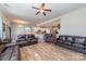 Open-concept living area with hardwood floors connecting the living room, kitchen, and dining space at 7034 Pin Oaks Dr, Denver, NC 28037