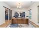 Spacious home office featuring a large desk, custom shelving, and natural light with a view of the outdoors at 7034 Pin Oaks Dr, Denver, NC 28037