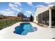 Backyard with freeform pool, white concrete deck, adjacent screened in porch, and mature landscaping at 7034 Pin Oaks Dr, Denver, NC 28037