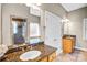 Bathroom vanity with granite countertop, decorative mirror, lighting, and tile flooring at 8005 Bridger Pt, Waxhaw, NC 28173