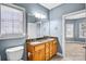 Bathroom featuring a double sink with granite counters, wood cabinets, and view to bedroom at 8005 Bridger Pt, Waxhaw, NC 28173