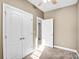 Neutral bedroom with double closet, an open door, and ceiling fan at 8005 Bridger Pt, Waxhaw, NC 28173