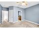 Bedroom with wall-to-wall carpet, a ceiling fan, and doors that lead to a full bathroom at 8005 Bridger Pt, Waxhaw, NC 28173