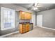 Bonus room featuring wood cabinets, stainless steel mini fridge, neutral carpet and ceiling fan at 8005 Bridger Pt, Waxhaw, NC 28173