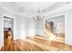 Formal dining room with hardwood floors, wainscoting, tray ceilings, and modern chandelier at 8005 Bridger Pt, Waxhaw, NC 28173