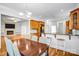 Open concept dining area adjacent to the kitchen, featuring wood floors and a breakfast bar at 8005 Bridger Pt, Waxhaw, NC 28173