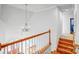 Stairwell with wood stairs and decorative chandelier with an open view to the entryway below at 8005 Bridger Pt, Waxhaw, NC 28173