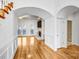 Bright foyer with hardwood floors and an archway leading to the living room with stone fireplace at 8005 Bridger Pt, Waxhaw, NC 28173