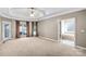 Large main bedroom featuring carpeting, windows with curtains and a view to the ensuite bath at 8005 Bridger Pt, Waxhaw, NC 28173