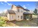 Exterior back view of home showing roofline, covered porch, and stucco at 8005 Bridger Pt, Waxhaw, NC 28173