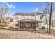 Back of home showing large screened-in porch and landscaping at 8005 Bridger Pt, Waxhaw, NC 28173