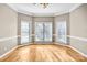 Sun-filled sitting room with hardwood floors and three windows, creating a cozy and inviting space at 8005 Bridger Pt, Waxhaw, NC 28173