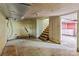 Spacious basement area, ready for renovation, with tile flooring and wooden stairs at 825 Rock Grove Church Rd, Salisbury, NC 28146