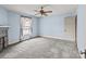 This light blue bedroom is complete with a ceiling fan, neutral carpet, and natural light at 825 Rock Grove Church Rd, Salisbury, NC 28146