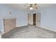 A vacant light blue bedroom with a decorative fireplace, ceiling fan and two doorways at 825 Rock Grove Church Rd, Salisbury, NC 28146