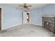 A bright blue bedroom features a ceiling fan, fireplace, and neutral carpeting at 825 Rock Grove Church Rd, Salisbury, NC 28146