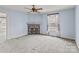 A blue bedroom with a charming decorative fireplace, ceiling fan and natural light at 825 Rock Grove Church Rd, Salisbury, NC 28146