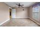 A simple bedroom features a neutral color scheme, tile flooring, and a single window at 825 Rock Grove Church Rd, Salisbury, NC 28146