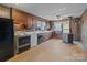 A vintage kitchen features wood paneling, retro appliances and a unique tile floor at 825 Rock Grove Church Rd, Salisbury, NC 28146