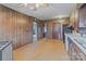 A large kitchen features wood walls, retro appliances and a patterned tile floor at 825 Rock Grove Church Rd, Salisbury, NC 28146