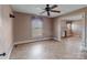 View of an empty room featuring tile floors, ceiling fan, and multiple windows with mini blinds at 825 Rock Grove Church Rd, Salisbury, NC 28146