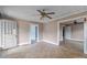 View of a living room featuring neutral walls, tile floors, ceiling fan and multiple doorways at 825 Rock Grove Church Rd, Salisbury, NC 28146