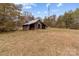 Rustic old wooden shed surrounded by bare trees and dormant grass at 825 Rock Grove Church Rd, Salisbury, NC 28146