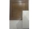 Wooden cabinet door with square inset panel next to a slab of white countertop material at 9508 Coast Laurel Nw Ave, Concord, NC 28027