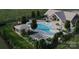 Aerial view of community pool featuring lounge chairs, lush landscaping, and a covered seating area at 9508 Coast Laurel Nw Ave, Concord, NC 28027