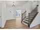 Bright foyer featuring hardwood floors, white walls, and a staircase with modern railings at 9508 Coast Laurel Nw Ave, Concord, NC 28027