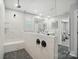 Bathroom featuring glass enclosed shower, marble tile, dark fixtures and a built-in bench at 9843 Quercus Ln, Huntersville, NC 28078