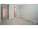Neutral bedroom with carpet flooring and access to other rooms in the house at 9843 Quercus Ln, Huntersville, NC 28078