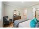 Bright bedroom showcasing a modern dresser, accent chair, and ensuite bathroom access at 9843 Quercus Ln, Huntersville, NC 28078