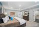 A well-lit bedroom with neutral tones, tray ceiling, and carpet flooring provides a calm and serene space at 9843 Quercus Ln, Huntersville, NC 28078