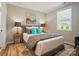 Cozy bedroom featuring a decorative rug, stylish furniture, and natural light from a window at 9843 Quercus Ln, Huntersville, NC 28078