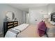 Tastefully staged bedroom with dresser and mirror, double door closet and soft lighting at 9843 Quercus Ln, Huntersville, NC 28078