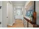 Inviting hallway showcasing elegant wood floors, tasteful decor, and a welcoming entrance leading to the rest of the home at 9843 Quercus Ln, Huntersville, NC 28078