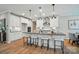 Modern kitchen with sleek white cabinets, stainless steel appliances, and a spacious center island with bar seating at 9843 Quercus Ln, Huntersville, NC 28078