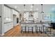 Modern kitchen with sleek white cabinets, stainless steel appliances, and a spacious center island with bar seating at 9843 Quercus Ln, Huntersville, NC 28078