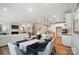 A dining area leading to a kitchen island, with a living room in the background, creating an open and connected living space at 9843 Quercus Ln, Huntersville, NC 28078