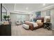 Expansive primary bedroom suite features a tray ceiling, accent furniture, and carpet flooring at 9843 Quercus Ln, Huntersville, NC 28078