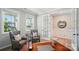 Serene office space featuring light walls, hardwood floors, and large windows, creating an inviting work environment at 9843 Quercus Ln, Huntersville, NC 28078