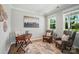Bright home office features hardwood floors, and two comfortable chairs creating a perfect space for work or relaxation at 9843 Quercus Ln, Huntersville, NC 28078